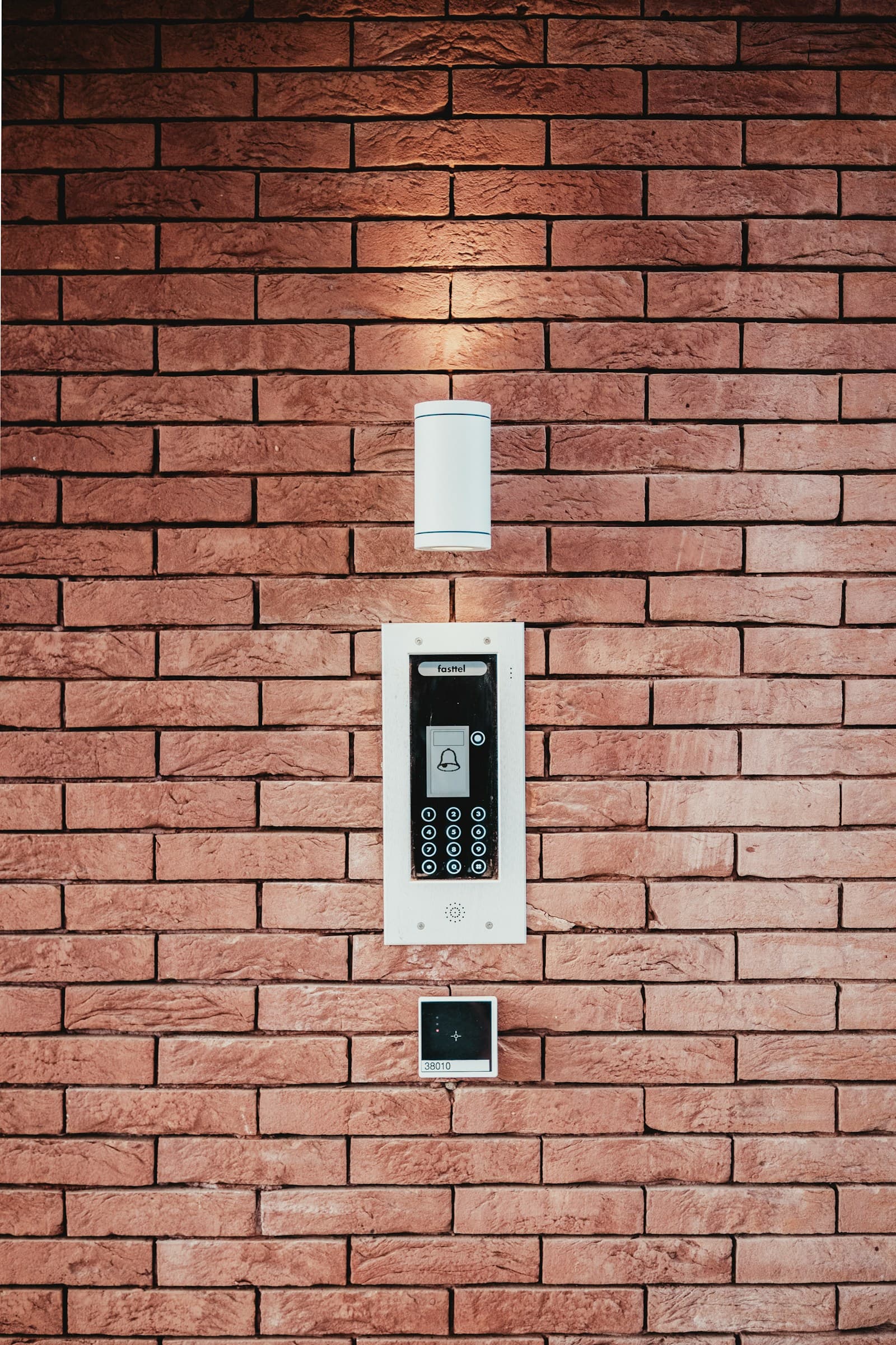 Wall-mounted access control reader and entry sconce