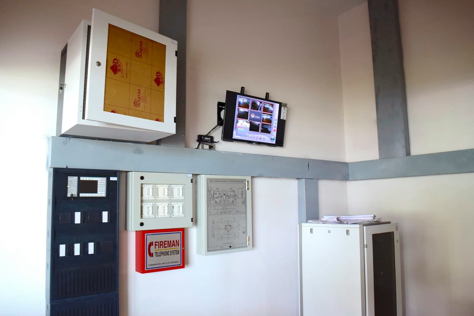 Fire alarm control panel display mounted on a wall